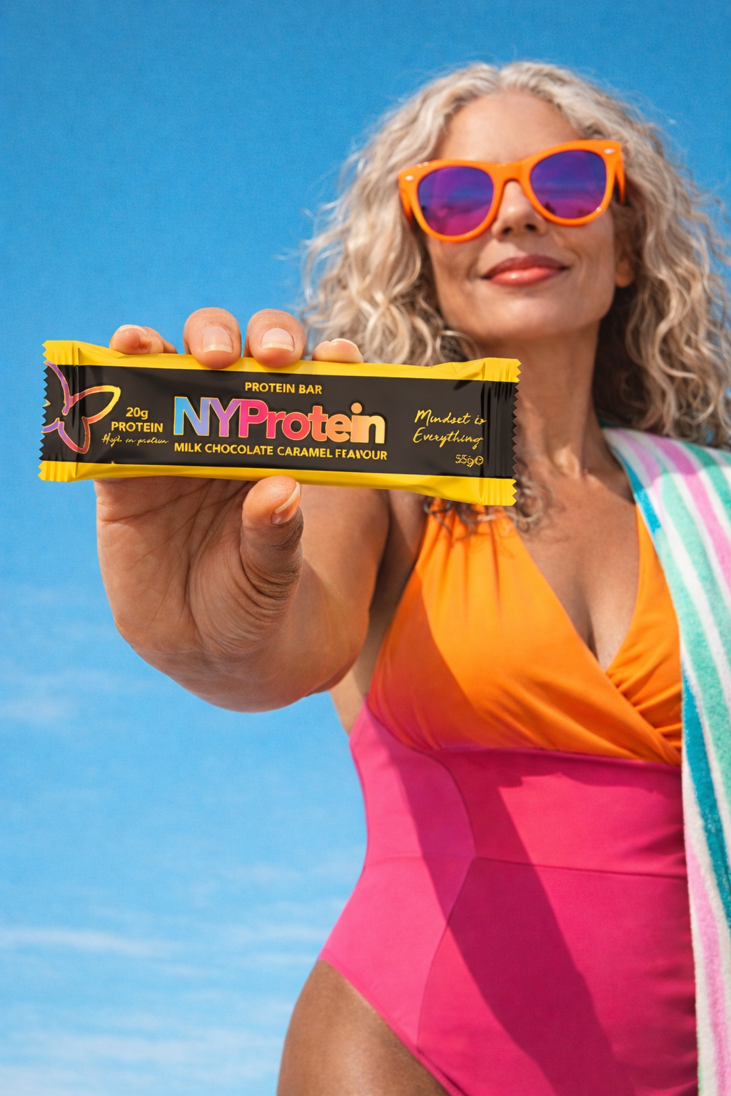 Customer at the beach holding a NYProtein bar