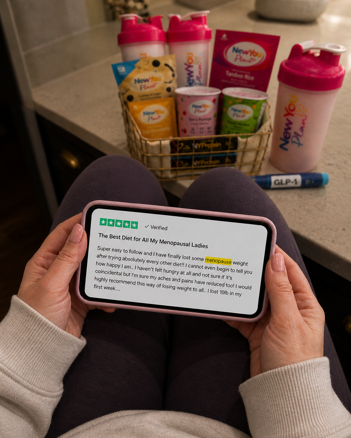 Customer reading a 5-star Trustpilot review next to a New You Plan bundle basket
